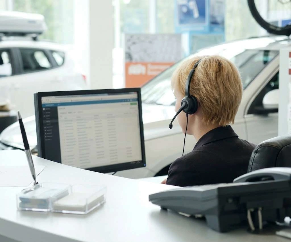 A BDC agent with a headset handling seller leads
